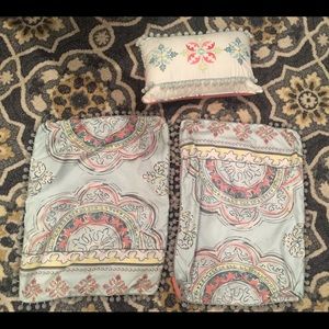 One decorative pillows and two pillow shams